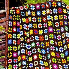 a crocheted blanket with flowers on it