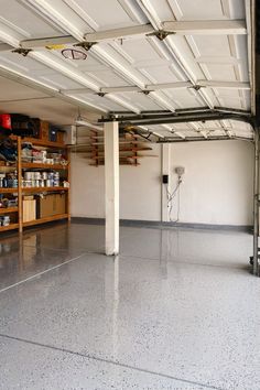 an empty garage with shelves and basketball hoop