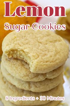 lemon sugar cookies stacked on top of each other in front of an orange and white plate