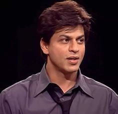 a young man wearing a shirt and tie