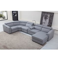 a grey sectional sofa sitting on top of a rug