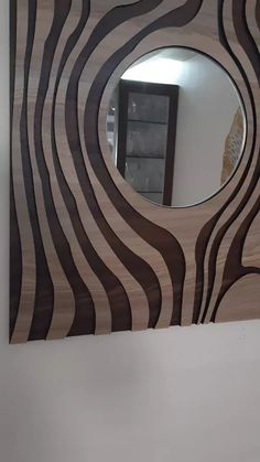 a mirror that is on the side of a wooden door with zebra stripes painted on it