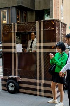 Customer standing in front of Burberry pop up cart