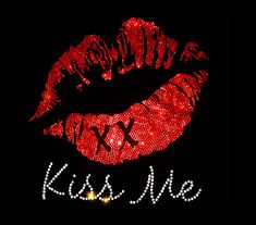 a red lipstick with the word kiss me written on it's side in front of a black background