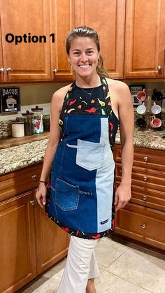 a woman standing in a kitchen wearing an apron