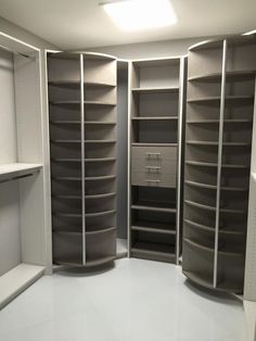 an empty walk in closet with lots of shelves