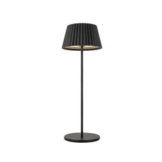 a black lamp with a white shade on it's base and a light bulb in the middle