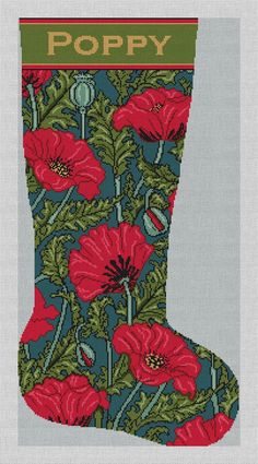 a cross stitch christmas stocking with red poppies on it and the word poppy written in gold