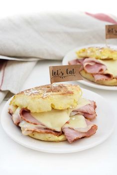 two white plates topped with ham and cheese