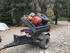 an atv trailer loaded with luggage and camping gear