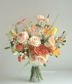 a vase filled with lots of different colored flowers