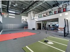 an indoor basketball court is shown in the middle of a large gym with several equipment