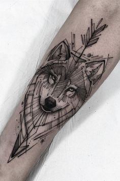 a man's arm with a tattoo on it and a wolf head in the middle