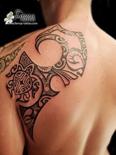 the back of a man's shoulder with an intricate tattoo design on his chest