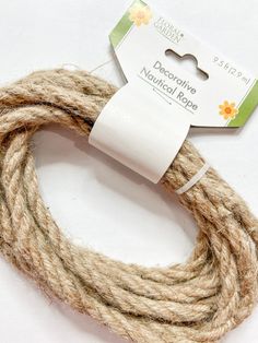 the rope is brown and white with a tag on it that says decorative natural rope