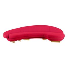 a red curved couch sitting on top of a white floor