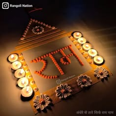 a lighted sign that says diya with candles around it