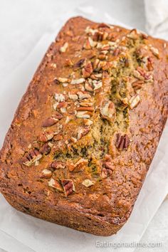 a loaf of bread with pecans on top