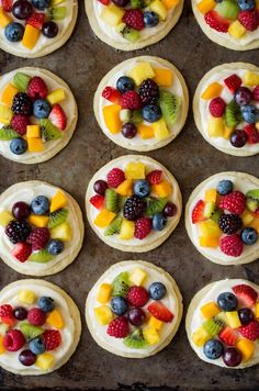 fruit pizzas are arranged on top of each other and ready to be baked in the oven