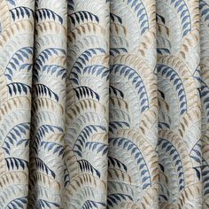 a curtain with blue and beige leaves on it