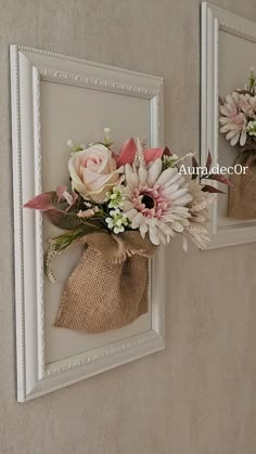 two framed pictures with burlocks and flowers on the wall next to each other