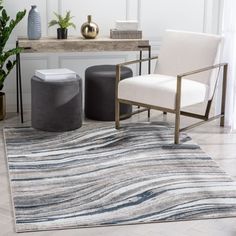 a chair and ottoman in a room with a rug on the floor next to it