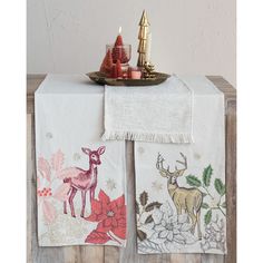 two napkins with deer and poinsettia on them