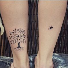 two people with matching tattoos on their feet, one has a tree and the other has a bird