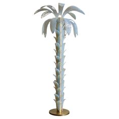 a tall white palm tree on a gold base