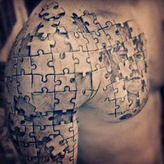 a man's back with puzzle pieces on it