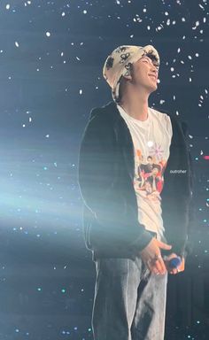 a young man standing on top of a stage