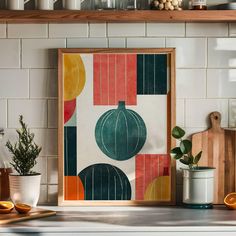 an art print is hanging on the wall above a kitchen counter with utensils and potted plants