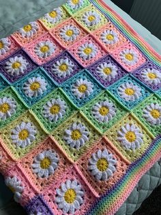 a crocheted blanket with flowers on it