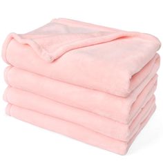 four pink blankets stacked on top of each other in front of a white background,