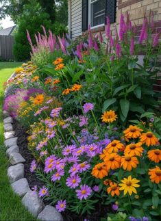 colorful flowers line the side of a house