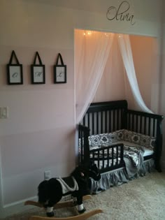 a baby's room with a crib and rocking horse