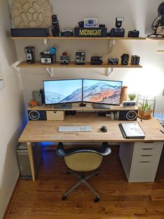 a computer desk with two monitors on it