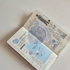 an open book with stickers on the pages