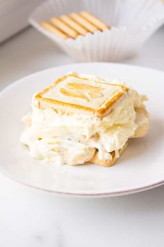 a white plate topped with a sandwich covered in cheese