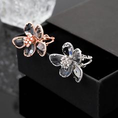 Our Crystal Flower Ring is a unique and stylish statement piece, perfect for collectors who appreciate craftsmanship and natural crystals Handmade with love, this ring offers multiple choices to suit any taste and occasion. It's an ideal personalized gift that can enhance your wardrobe and personality with the healing power of crystal. Crafted with an alloy and electroplated with rose gold, this exquisite ring features a stunning floral design with artificial gems/semi-precious stones. Individua Rose Gold Flower Rings For Party, Rose Gold Flower Jewelry For Parties, Rose Gold Open Ring Jewelry For Party, Rose Gold Crystal Ring Jewelry, Rose Gold Crystal Jewelry With Flower Shape, Rose Gold Crystal Flower-shaped Jewelry, Rose Gold Crystal Flower Jewelry, Elegant Rose Gold Open Crystal Ring, Crystal Open Ring As Gift