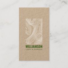 a business card with an abstract design on the front and bottom, in green ink