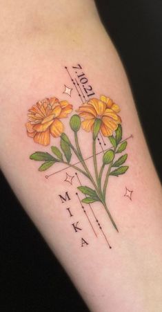 a tattoo with yellow flowers on the arm