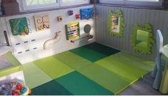 a child's playroom with green and yellow flooring