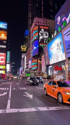 a busy city street at night with neon signs and billboards on the buildings in the background