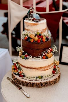 a three tiered cake sitting on top of a table next to a silver fork