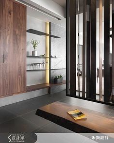 the interior of a modern house with wood and glass doors, shelving units, and bookshelves