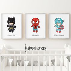 three superheros are hanging on the wall above a crib