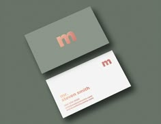 a business card with the letter m on it and a red logo in the middle