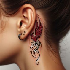 a woman's ear with a tattoo design on it