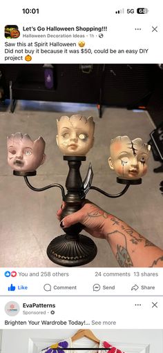 a person holding a candle holder with three cats on it